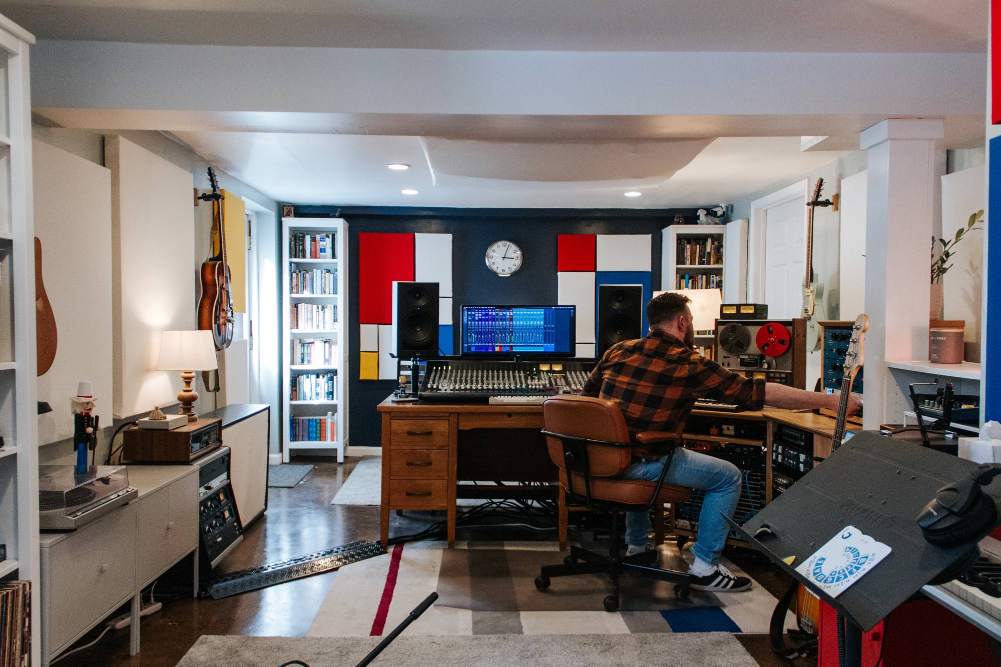 Ben adjusting equipment while recording in Shattered Glass Records Studio.